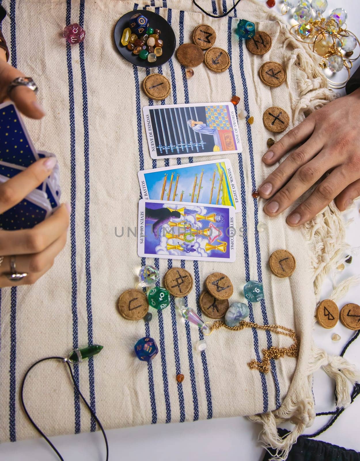 A woman fortuneteller tells a man on tarot cards. Selective focus. People.