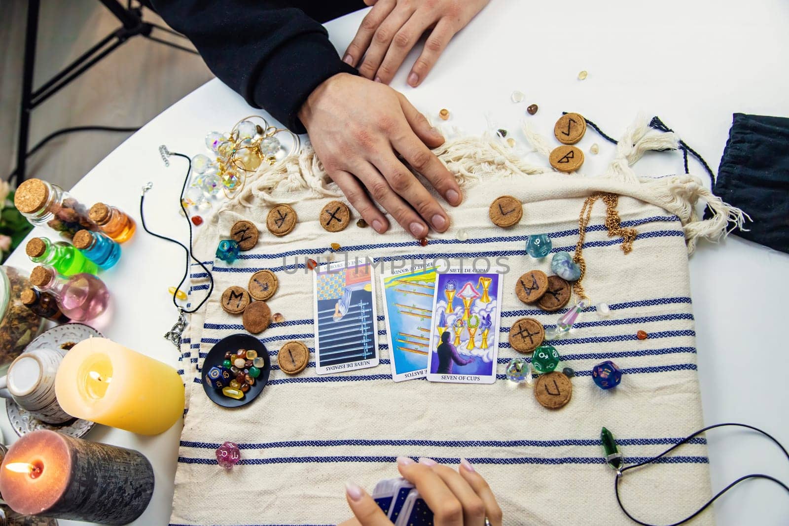 A woman fortuneteller tells a man on tarot cards. Selective focus. People.