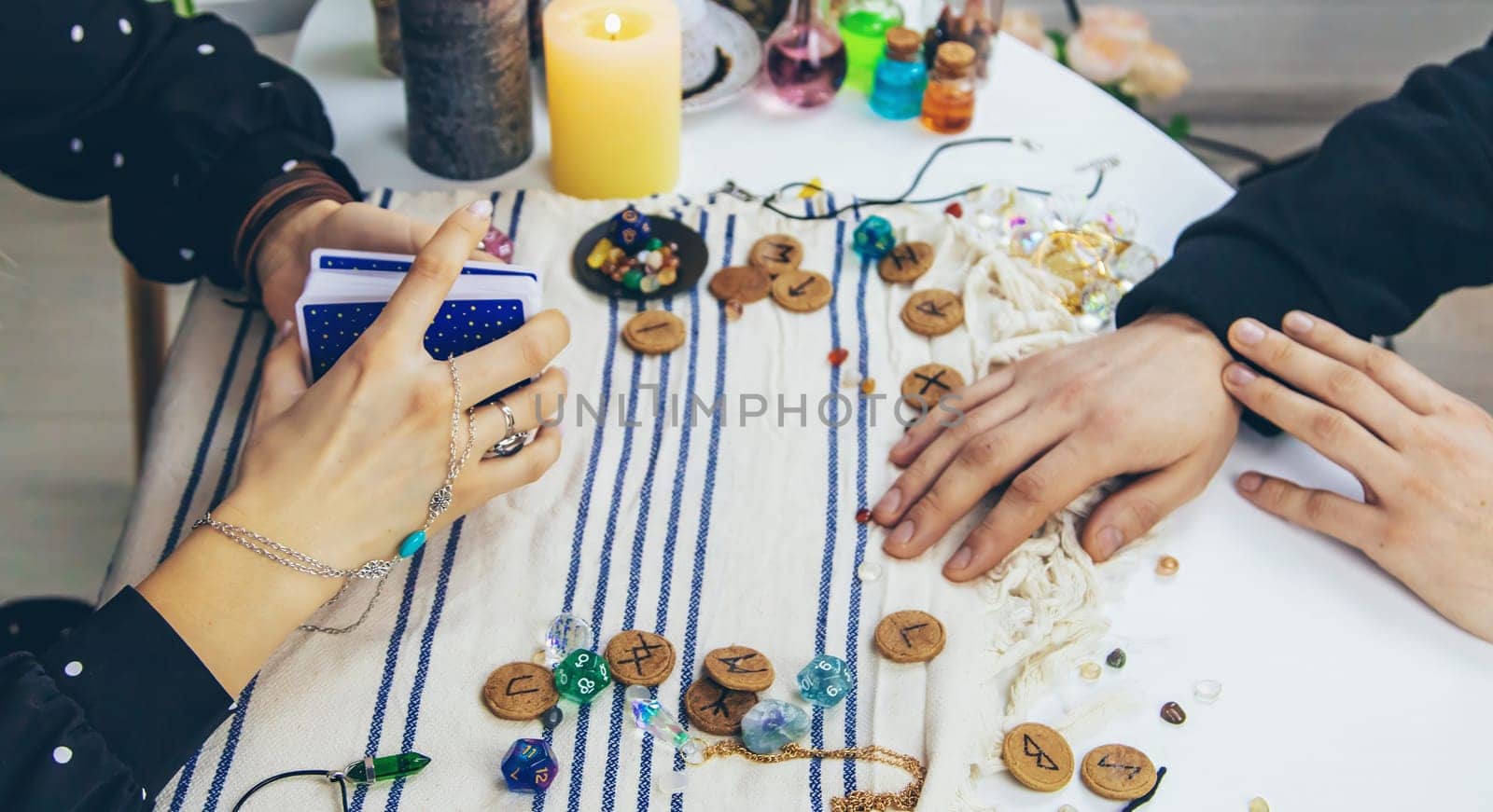 A woman fortuneteller tells a man on tarot cards. Selective focus. People.
