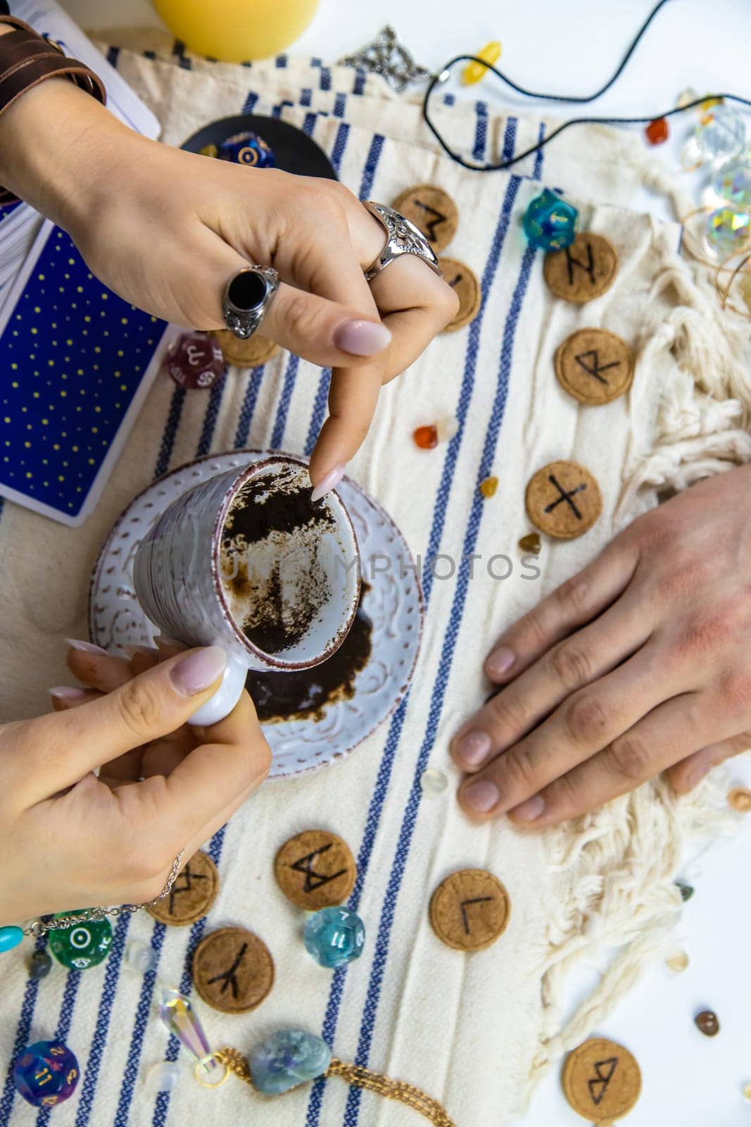 A fortune teller reads fortunes on coffee grounds. Selective focus. Woman.