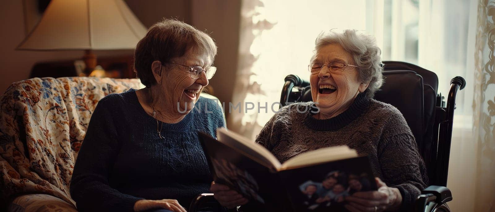 Two joyful senior women in wheelchairs share a lighthearted moment, laughing together while reminiscing over a cherished book, showcasing friendship and happiness.