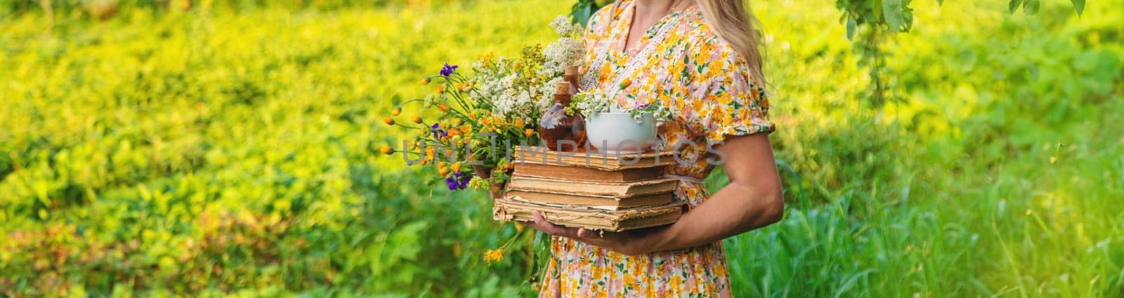 Woman with medicinal herbs in a meadow. Selective focus. nature.