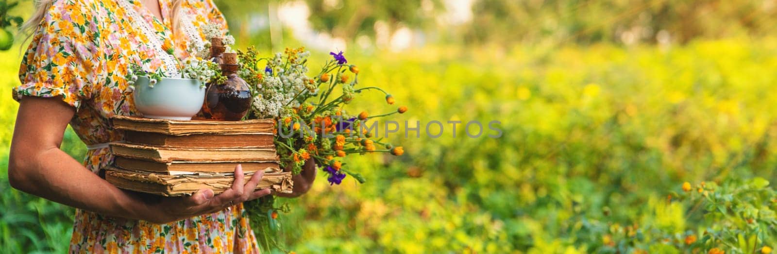 Woman with medicinal herbs in a meadow. Selective focus. nature.