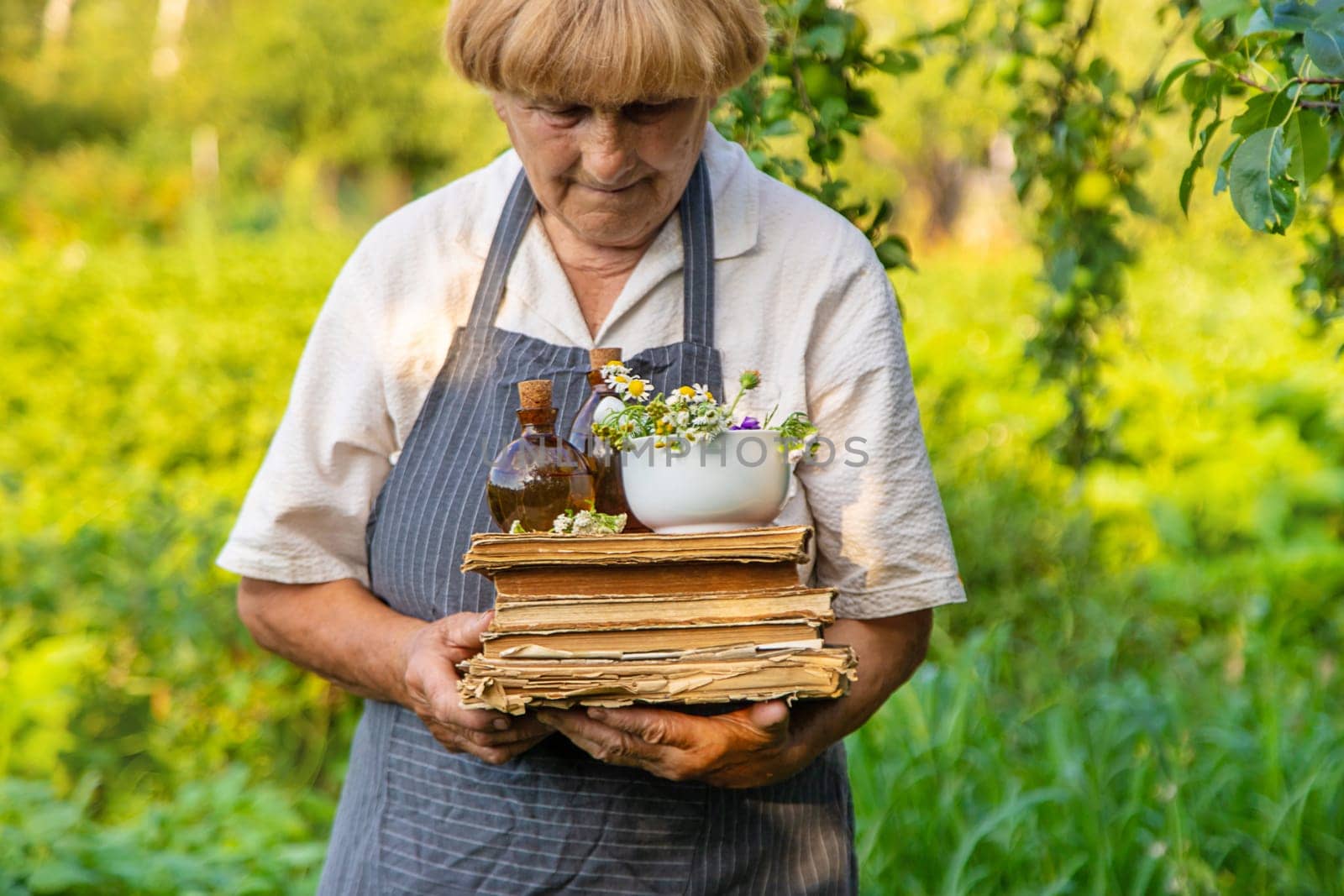 Woman with medicinal herbs in a meadow. Selective focus. nature.