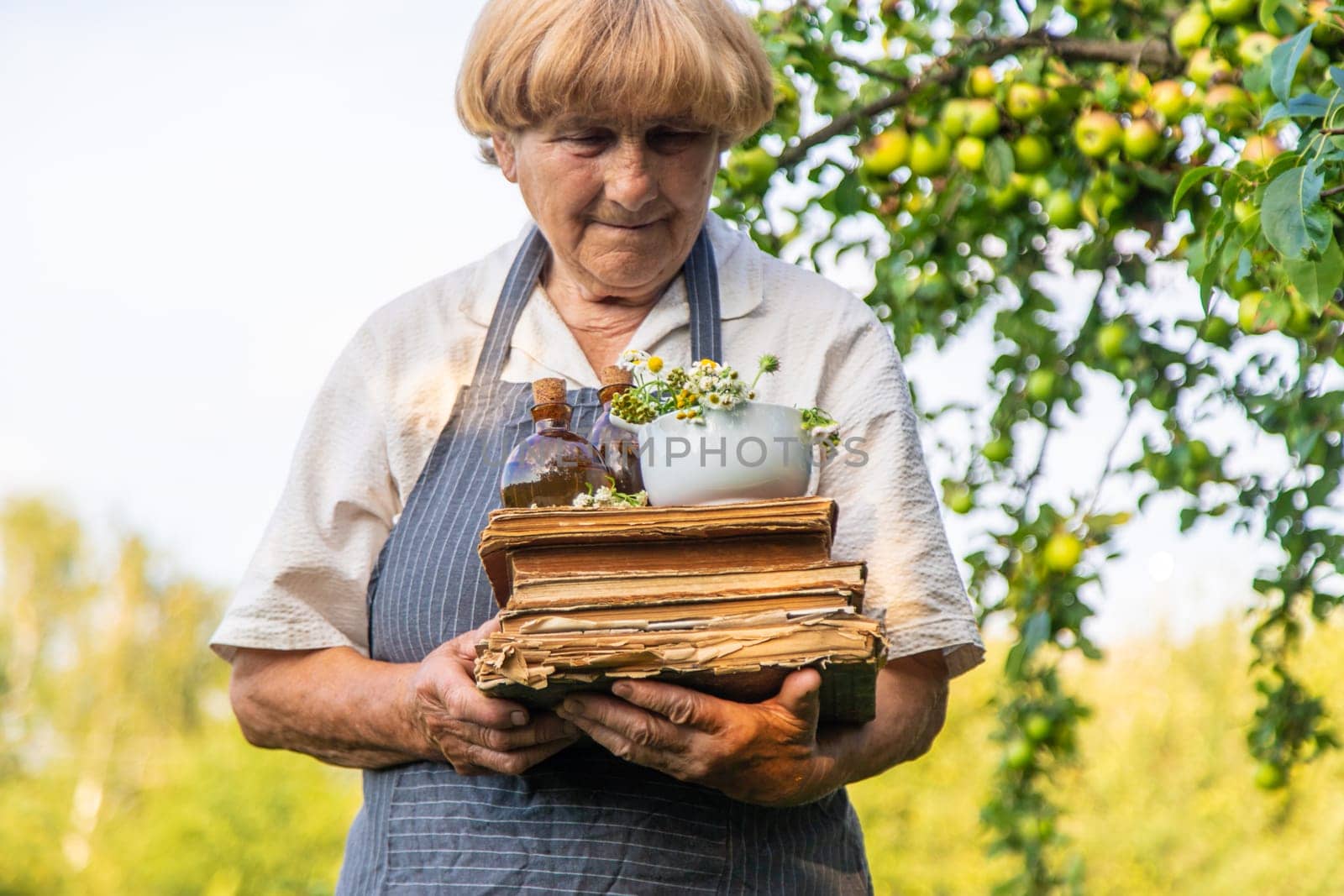 Woman with medicinal herbs in a meadow. Selective focus. nature.