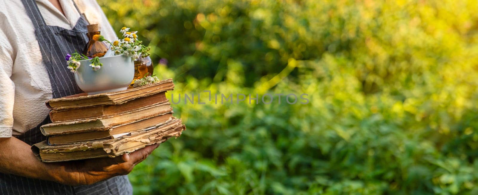 Woman with medicinal herbs in a meadow. Selective focus. nature.