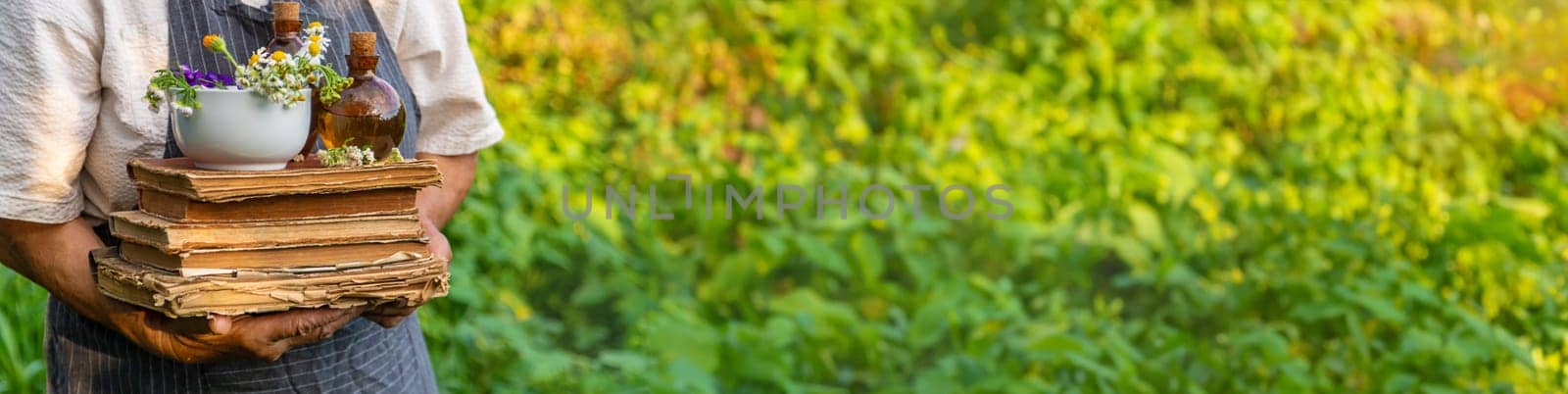 Woman with medicinal herbs in a meadow. Selective focus. nature.