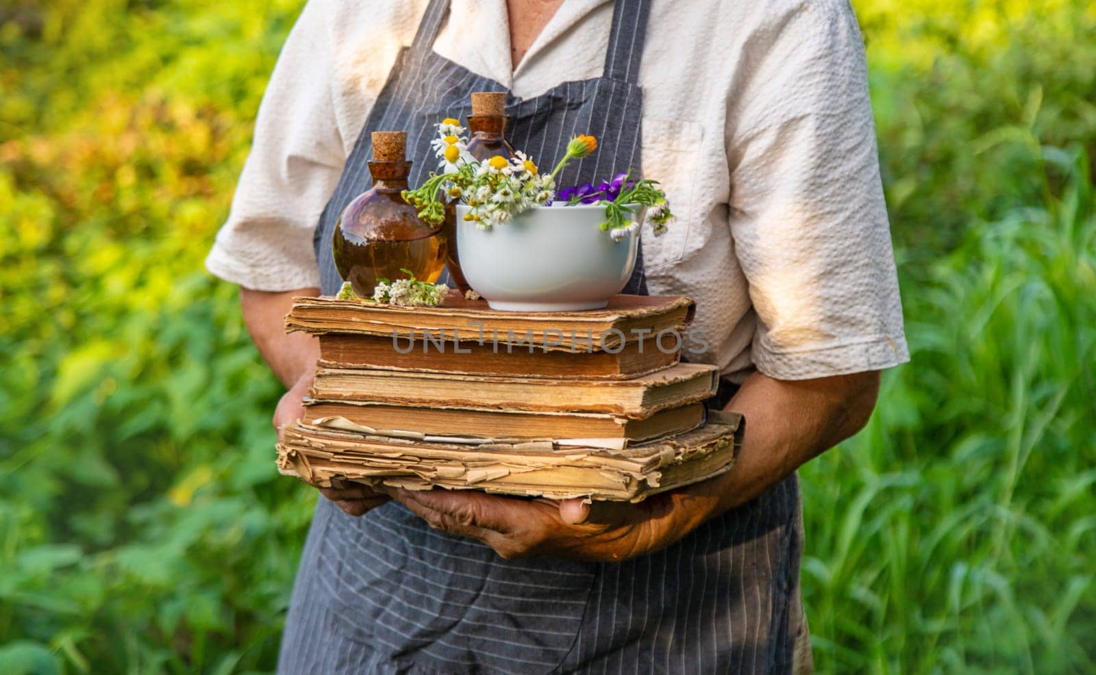 Woman with medicinal herbs in a meadow. Selective focus. nature.