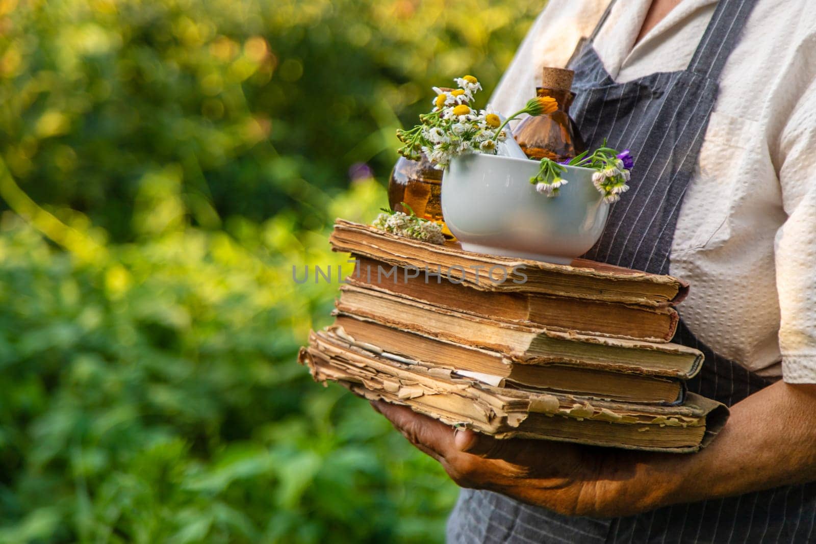 Woman with medicinal herbs in a meadow. Selective focus. nature.