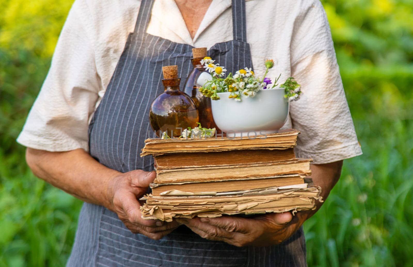 Woman with medicinal herbs in a meadow. Selective focus. nature.