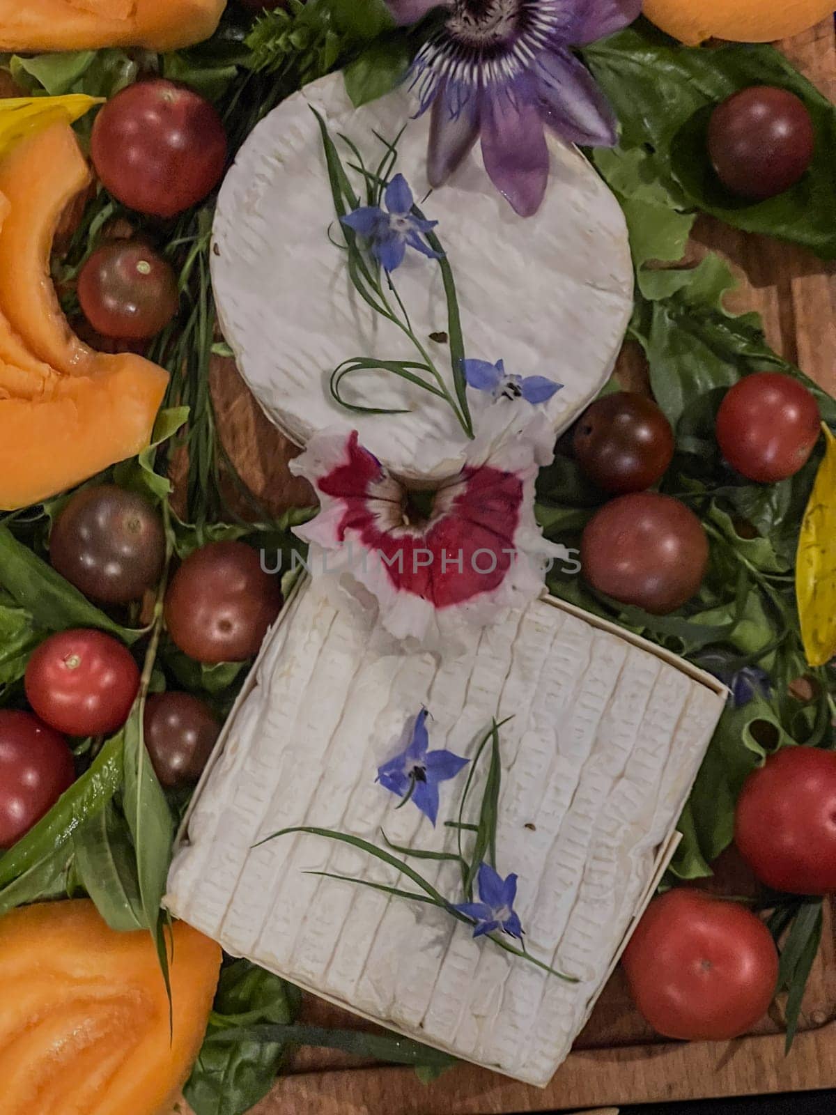 Selection of French cheeses from Normandy, AOP, Livarot, Neufchatel, Pont l'eveque, Rye bread, figs, walnuts, grapes, elderberry gelee. High quality photo