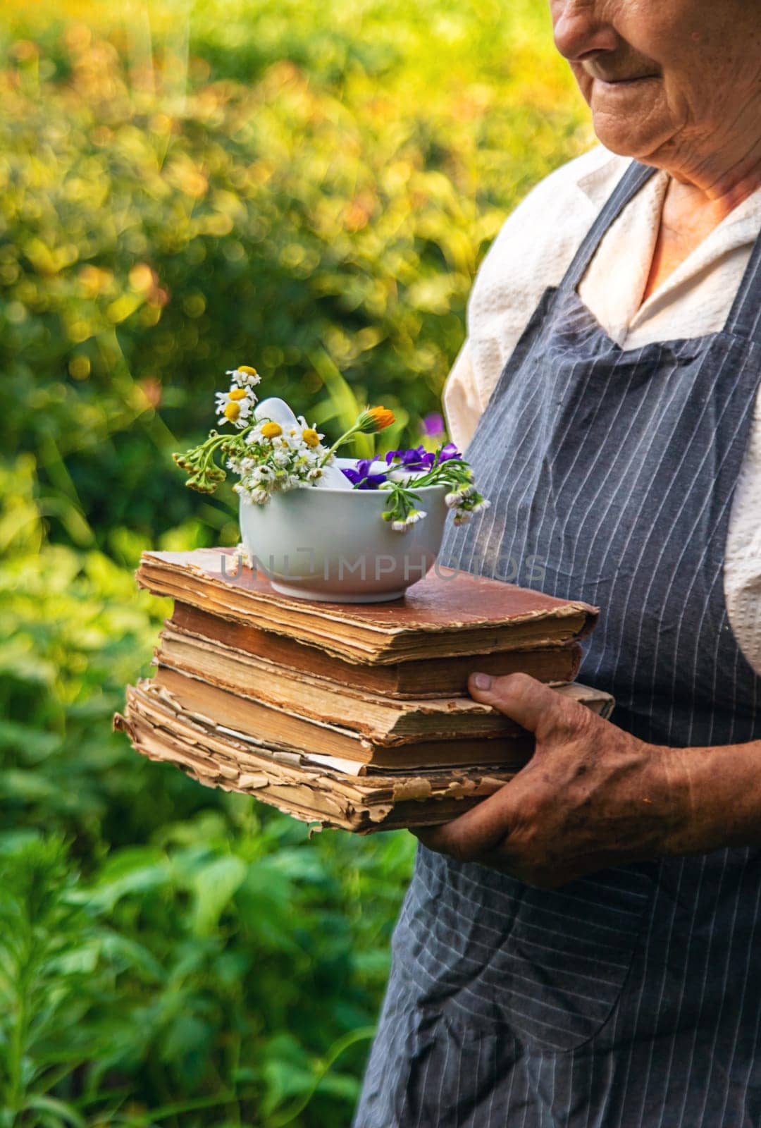 Woman with medicinal herbs in a meadow. Selective focus. nature.