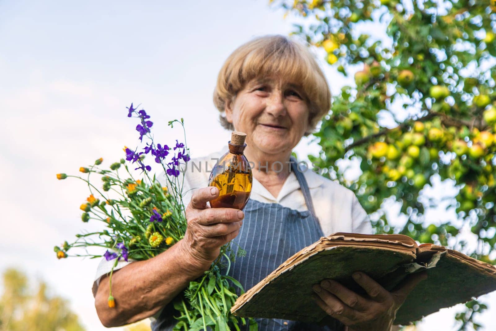Woman with medicinal herbs in a meadow. Selective focus. nature.