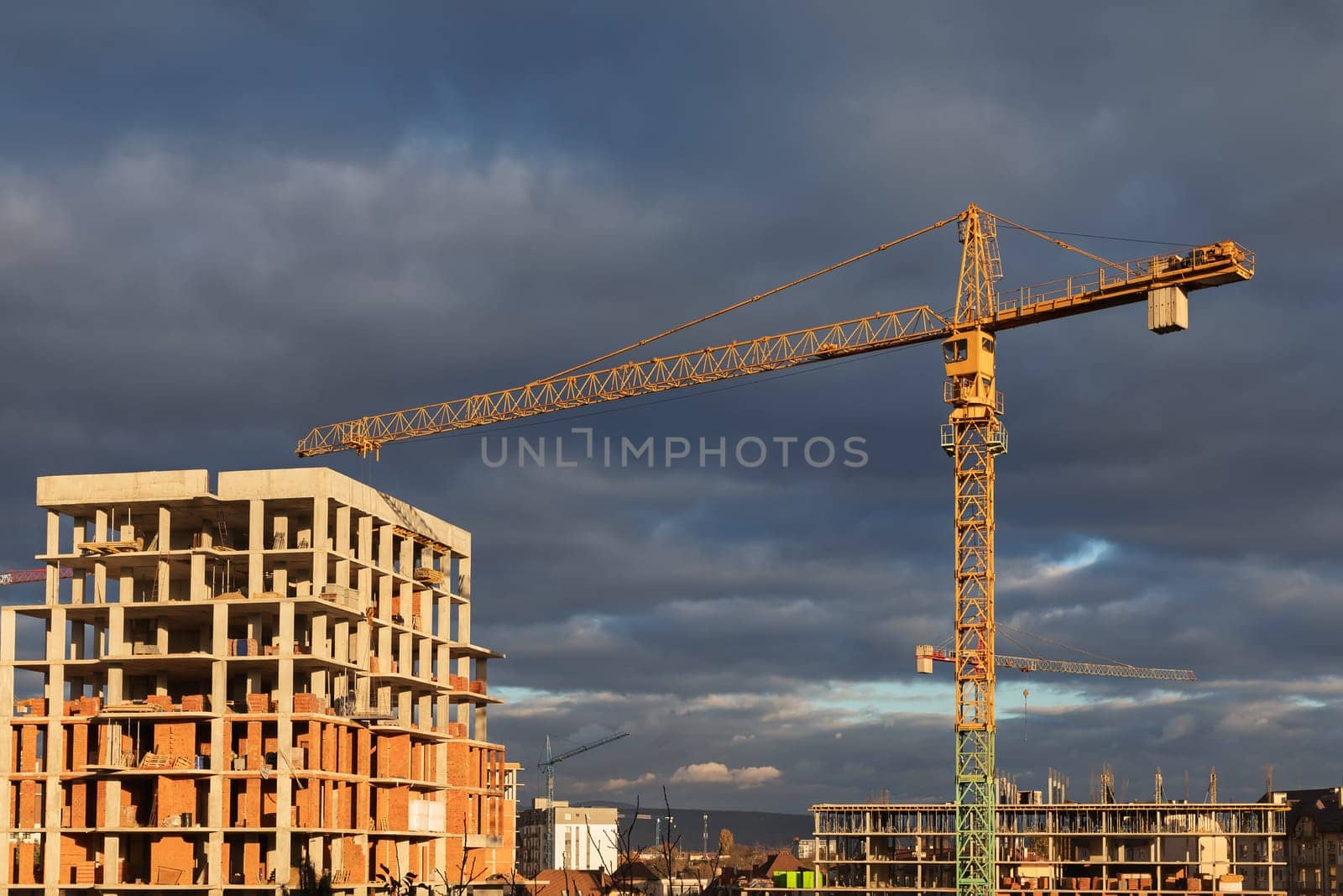 Construction boom in western Ukraine. An urban landscape showing cranes and buildings at various construction stages.