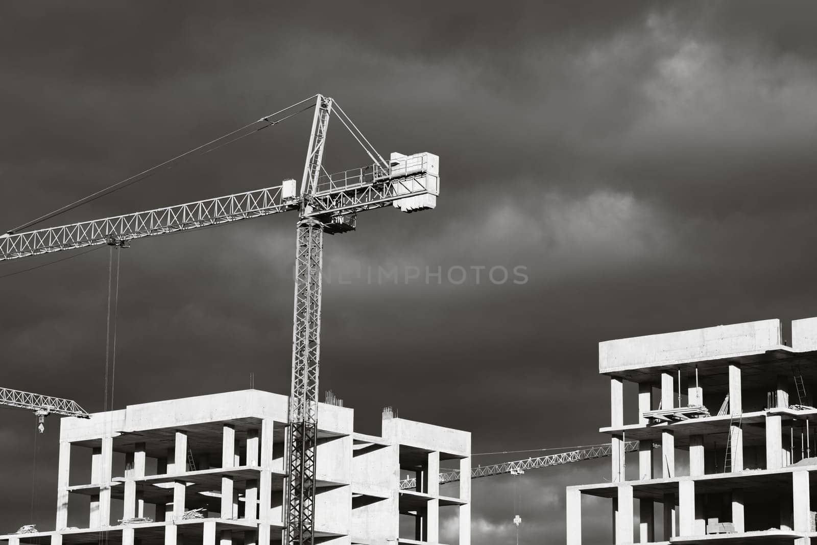 Construction boom in western Ukraine. High-rise buildings under construction, featuring unfinished concrete and brick structures.