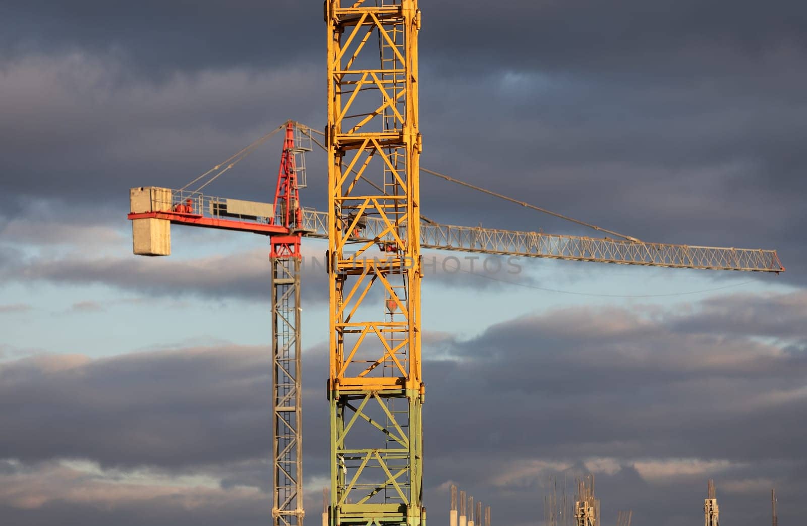 Construction boom in western Ukraine. Sunset light highlights cranes and buildings in a city under development.