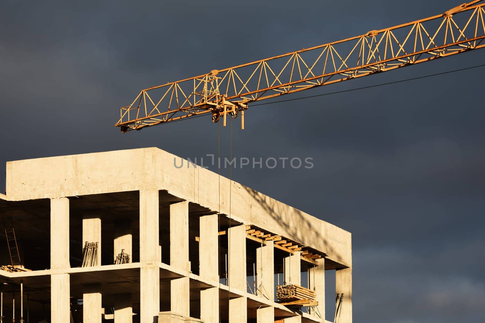 Construction boom in western Ukraine. Sunset light highlights cranes and buildings in a city under development.