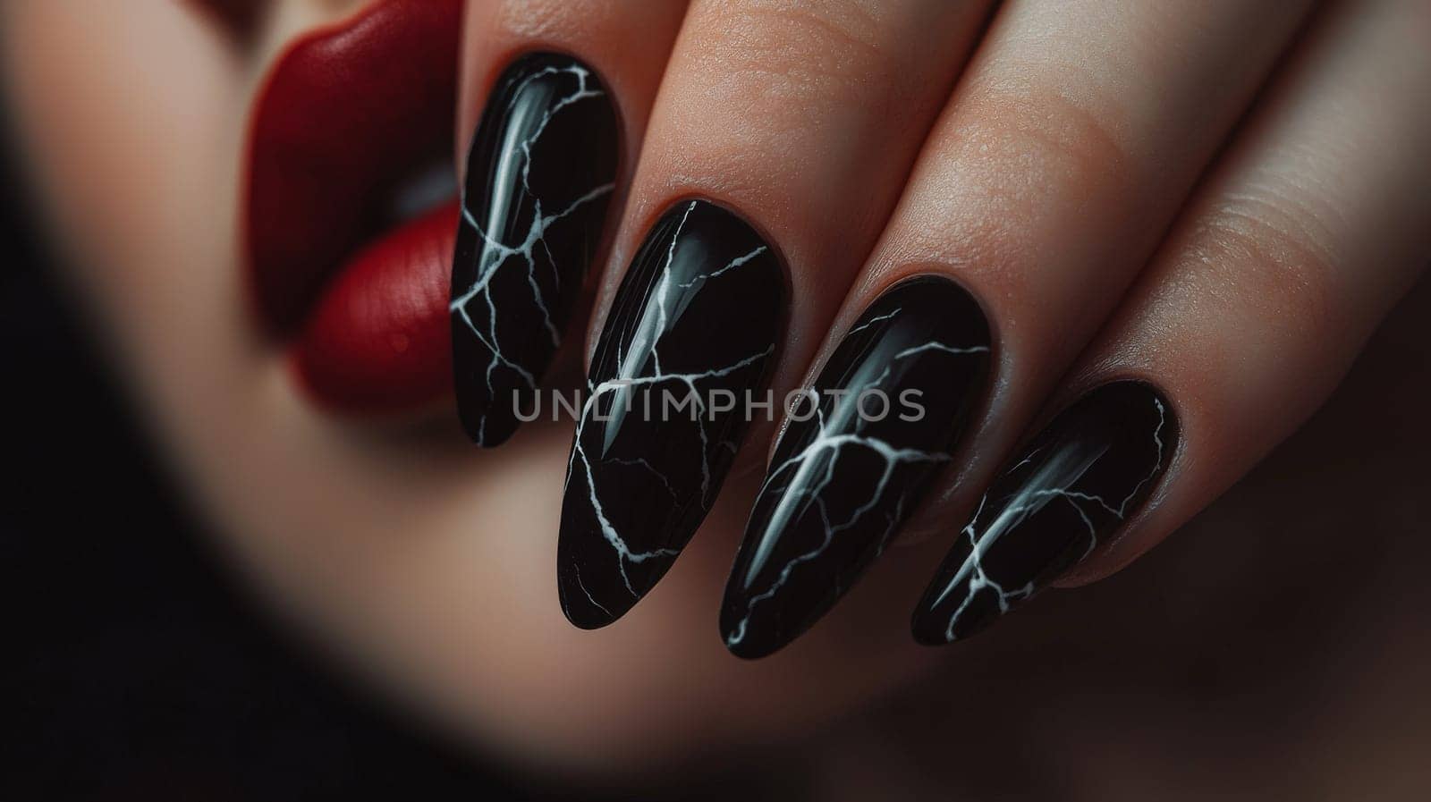 Close-up of a woman's hand showcasing striking black marble nail art. the elegant manicure contrasts with her bold, red lips, embodying sophistication and style, ideal for fashion and beauty themes.
