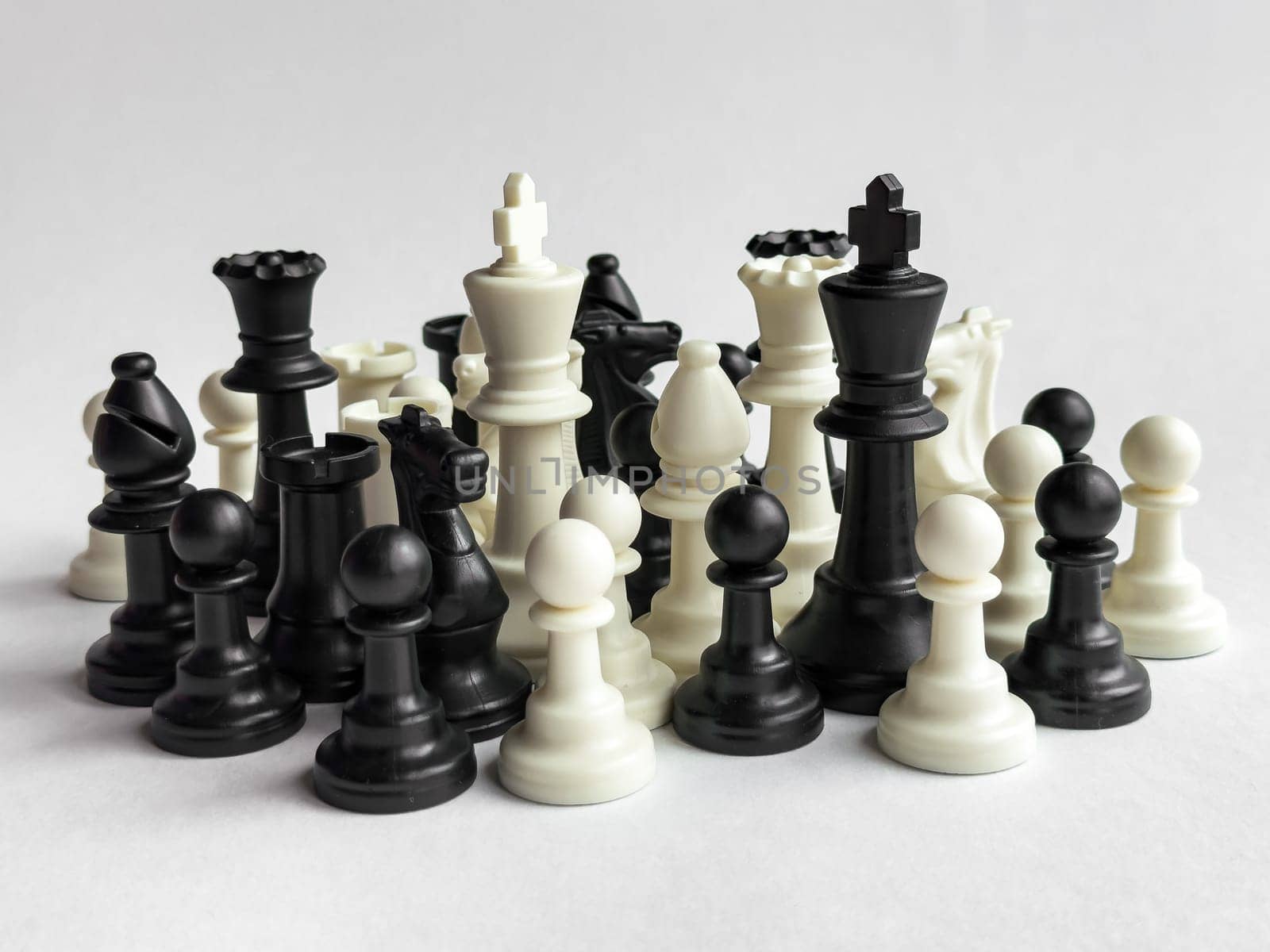 Abstract chess pieces arrangement on light background.