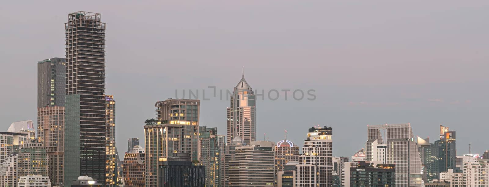 Bangkok, Thailand - 31 Dec, 2022 - Panorama viewed of Bangkok downtown cityscape in Business district with bright glowing lights at night. City night view of Bangkok city skyscrapers after sunset, Space for text, Selective Focus.