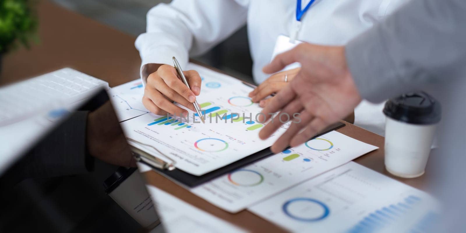 Close up business team analyzes financial business finance reports on laptop and graph documents during corporate meeting discussion showing successful teamwork, business meeting ideas.