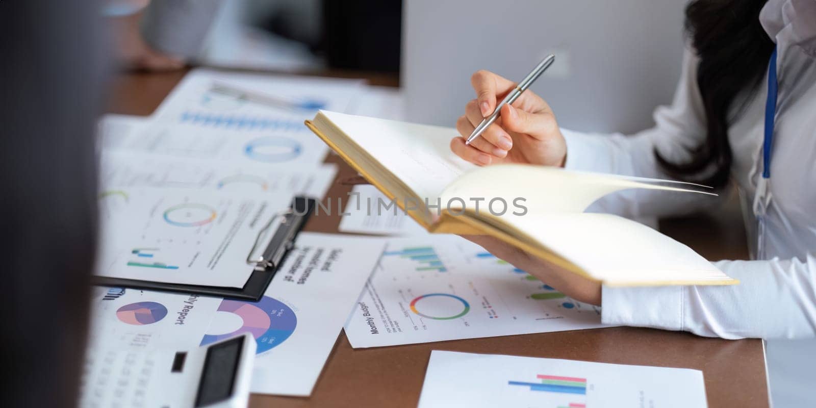 Close up business team analyzes financial business finance reports on laptop and graph documents during corporate meeting discussion showing successful teamwork, business meeting ideas by nateemee
