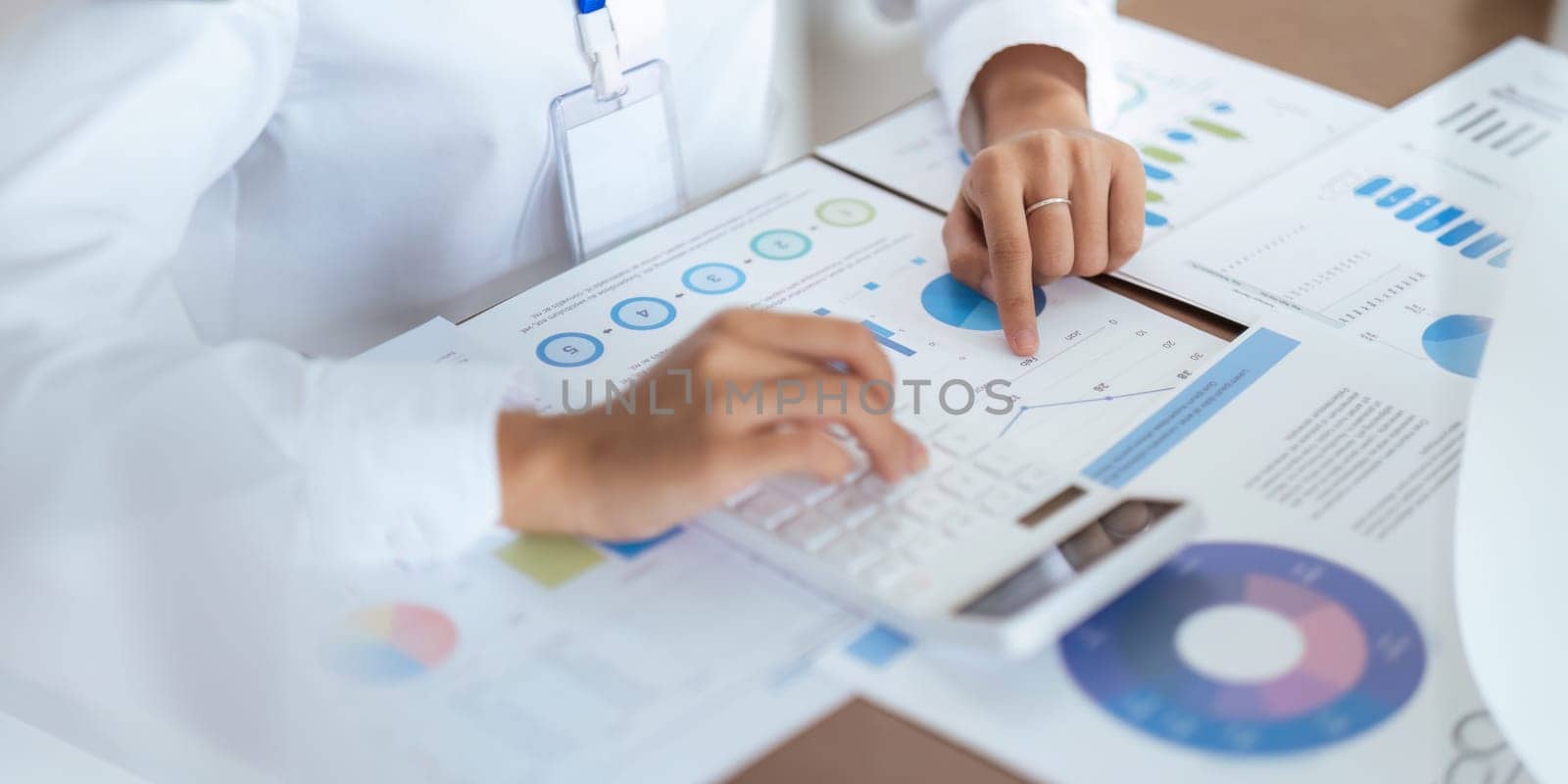 Close up business team analyzes financial business finance reports on laptop and graph documents during corporate meeting discussion showing successful teamwork, business meeting ideas by nateemee