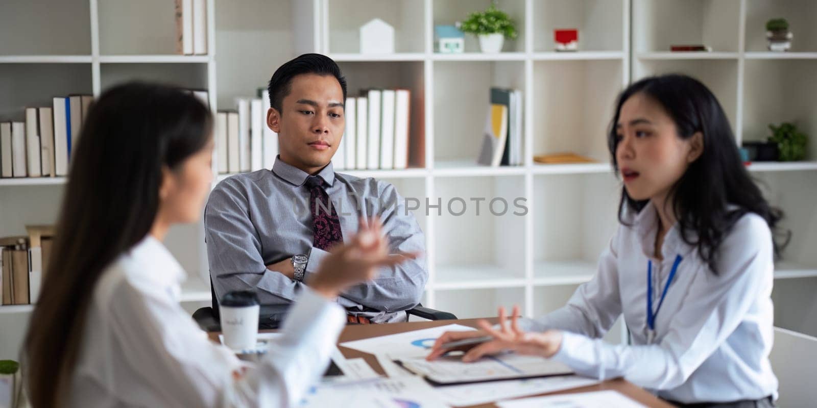 Asian young businesspeople are stress while working in meeting room, Tired businessman with headache at office, feeling sick at work by nateemee