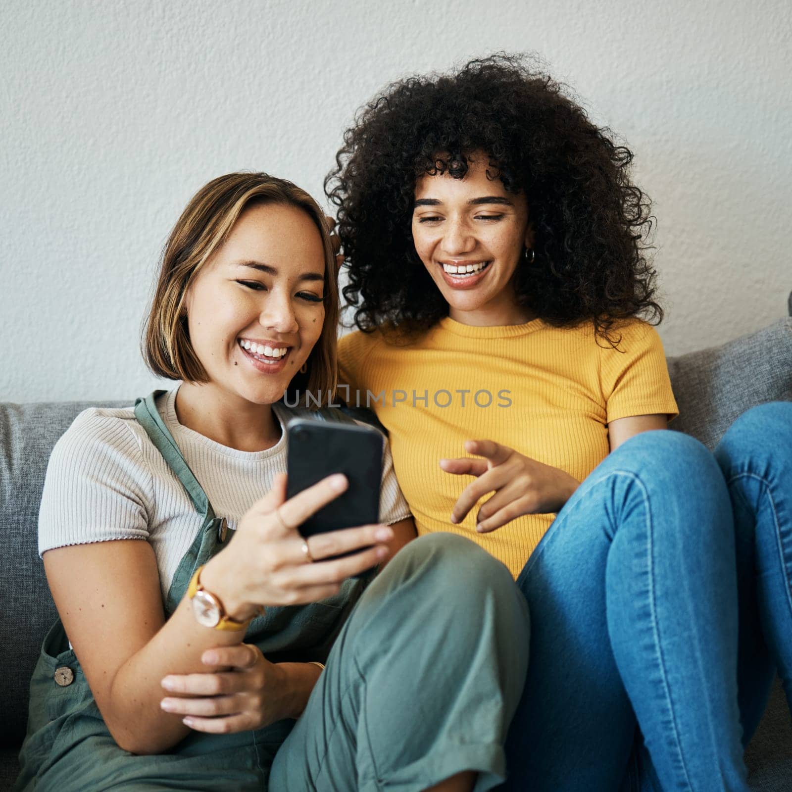 Friends, relax on sofa with smartphone and chat online with communication, funny meme and reading text message. Women with technology, mobile app and typing on social media with connectivity at home.