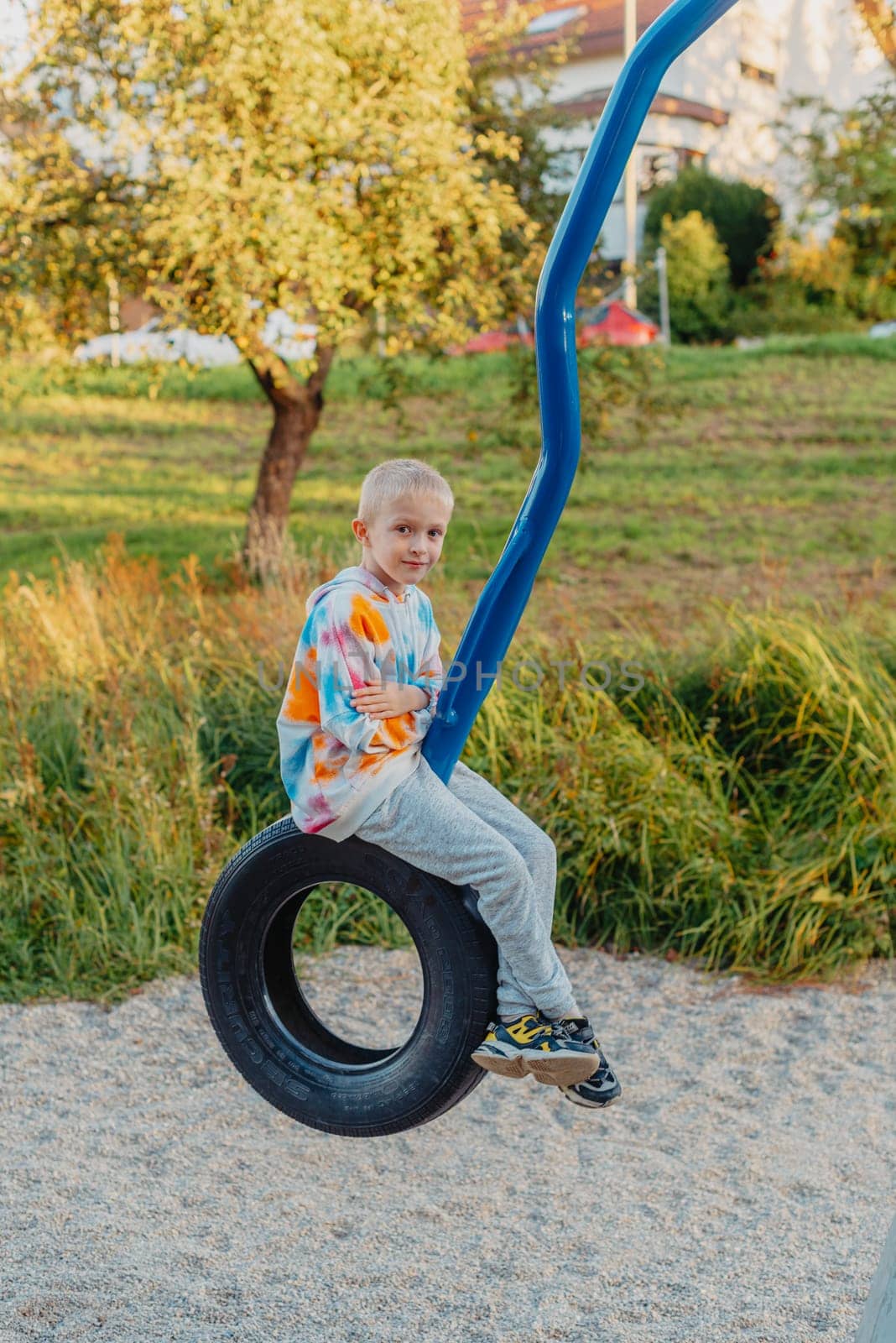 Funny cute happy baby playing on the playground. The emotion of happiness, fun, joy. Smile of a child. boy playing on the playground by Andrii_Ko