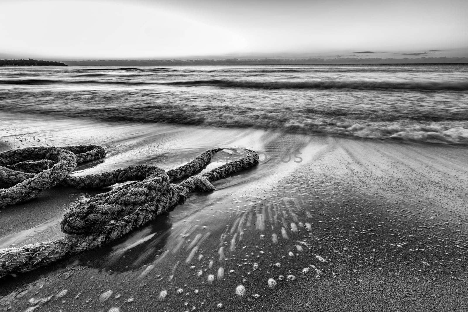 Scenic view of boat rope on the beach. Black and white
