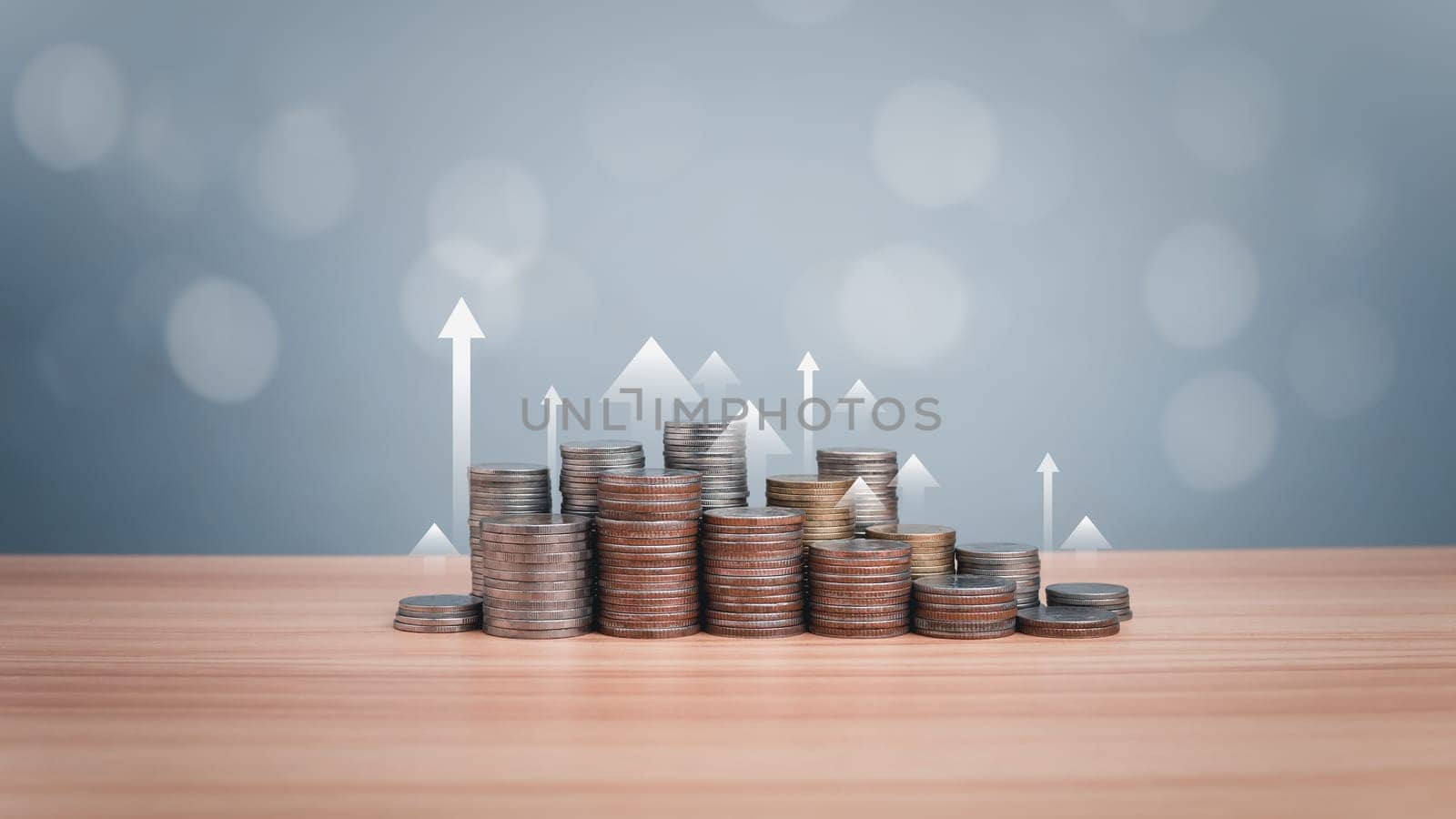 Coins are lined up on a wooden floor along with index charts, arrows and candlesticks. Represents financial, economic, business growth concepts. Financial success concept. Abstract finance background. by Unimages2527