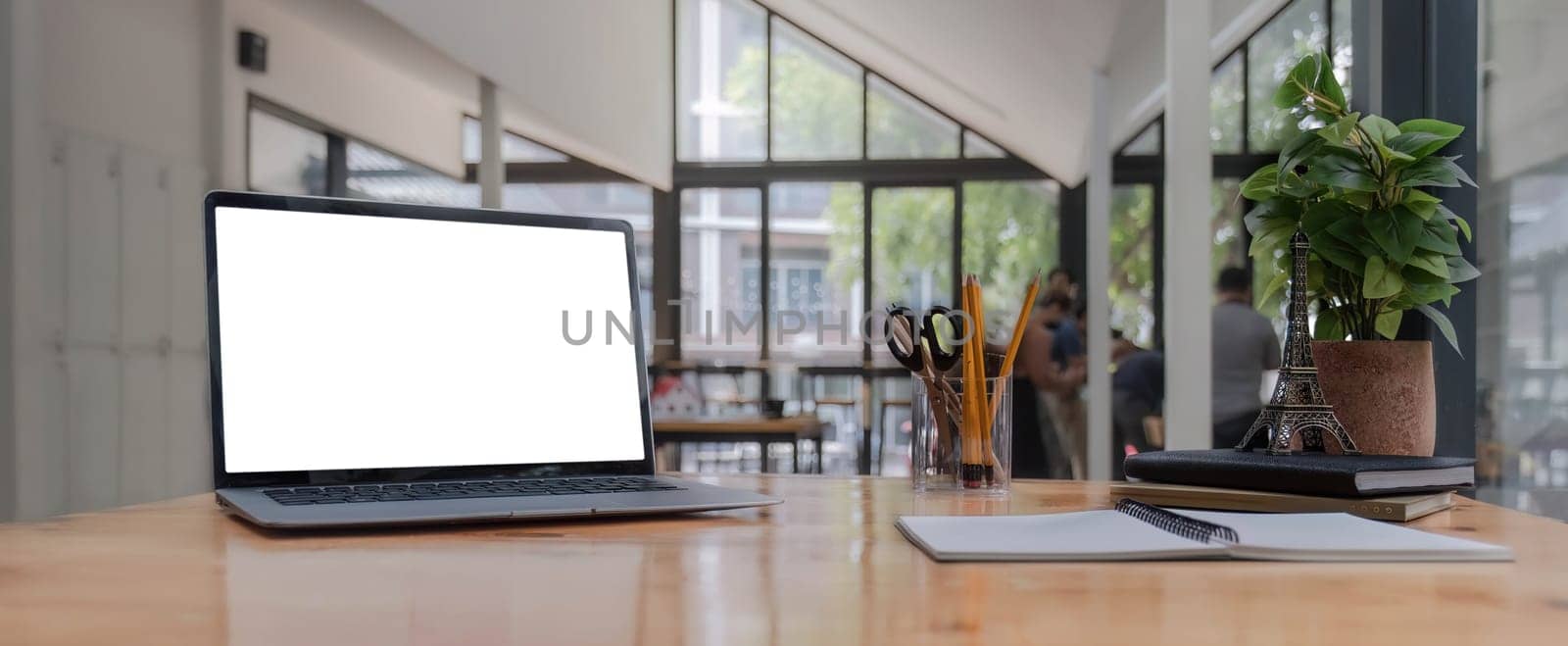 modern laptop computer with blank screen at workplace in office. finance report and calculator accounting on wooden table by wichayada