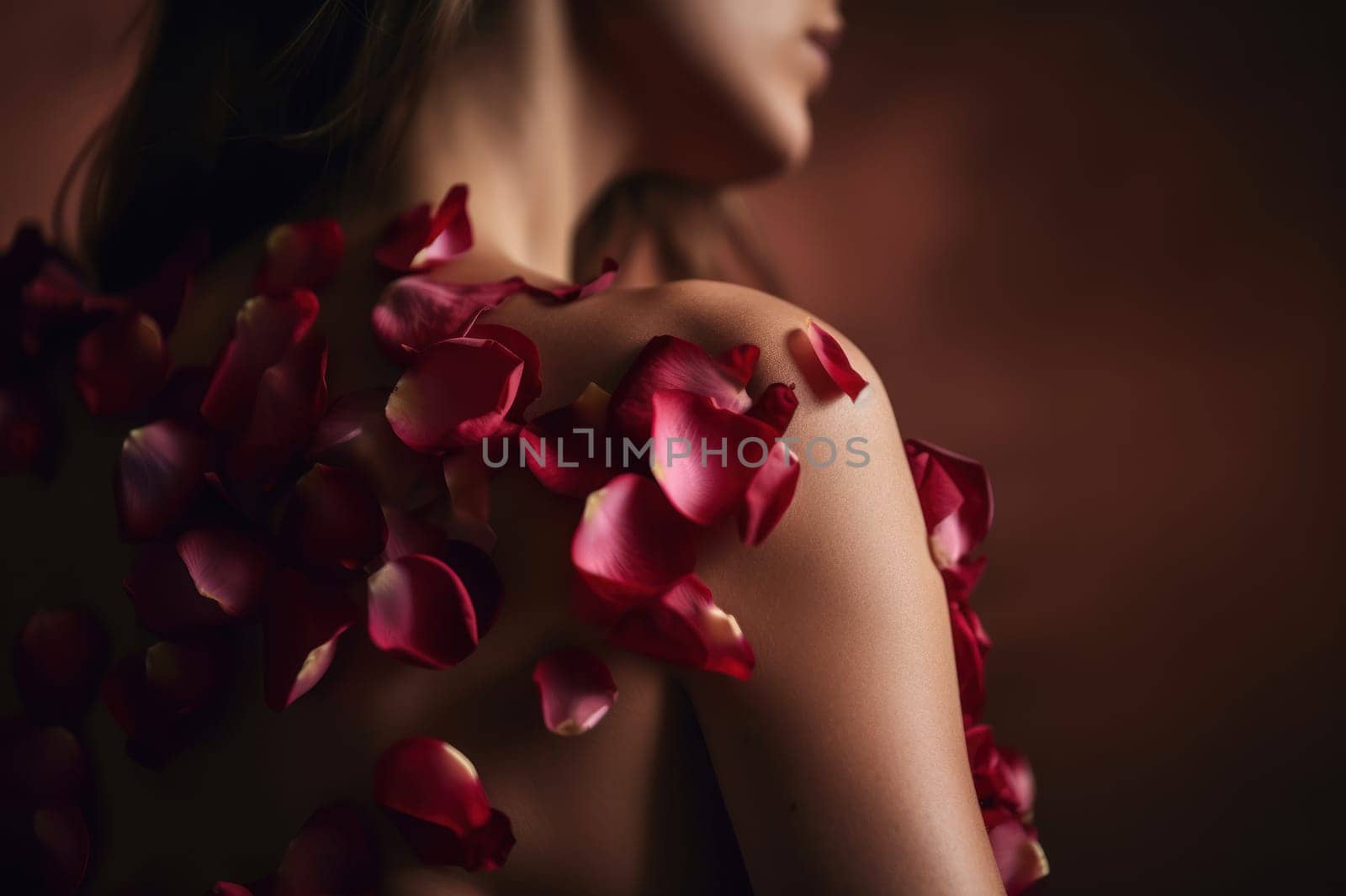 Red petals grew on the shoulder of a beautiful young woman. Concept for beauty product presentation. Photorealistic illustration generative AI. by julyKoph