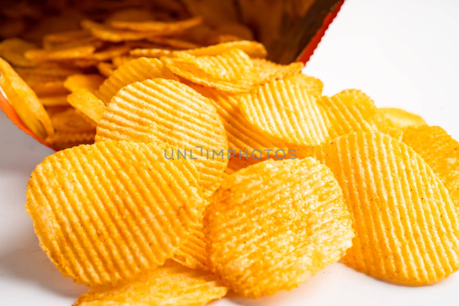 Potato chips, delicious BBQ seasoning spicy for crips, thin slice deep fried snack fast food in open bag. by pamai