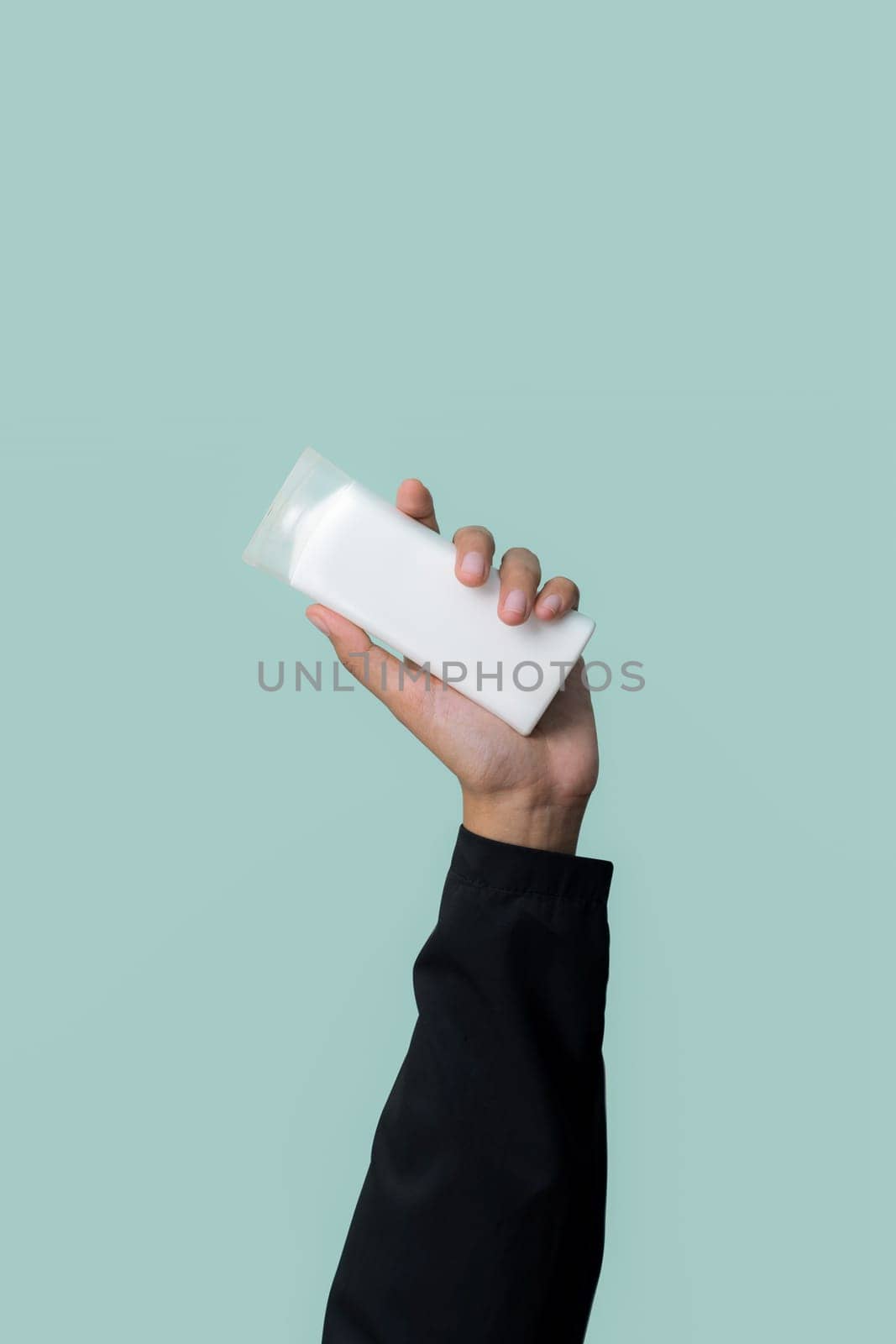 Businessman's hand holding plastic bottle on isolated background. Quaint by biancoblue