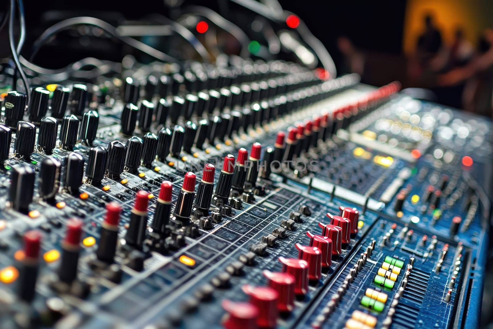 A large sound board with many knobs and buttons. The buttons are red and green. The buttons are arranged in rows
