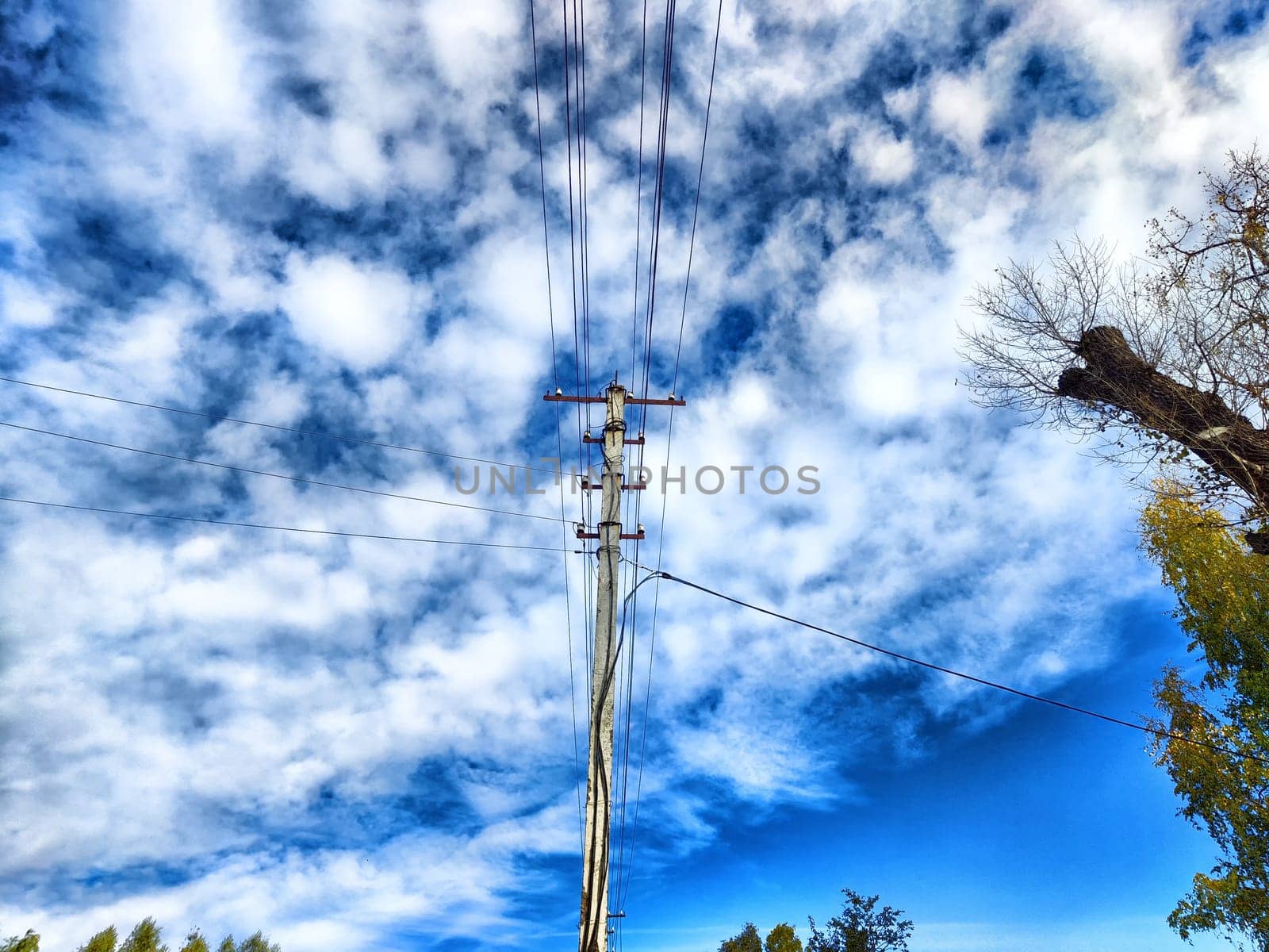 Old pole with wires against the sky. Electric transmission line, Eco-friendly energy