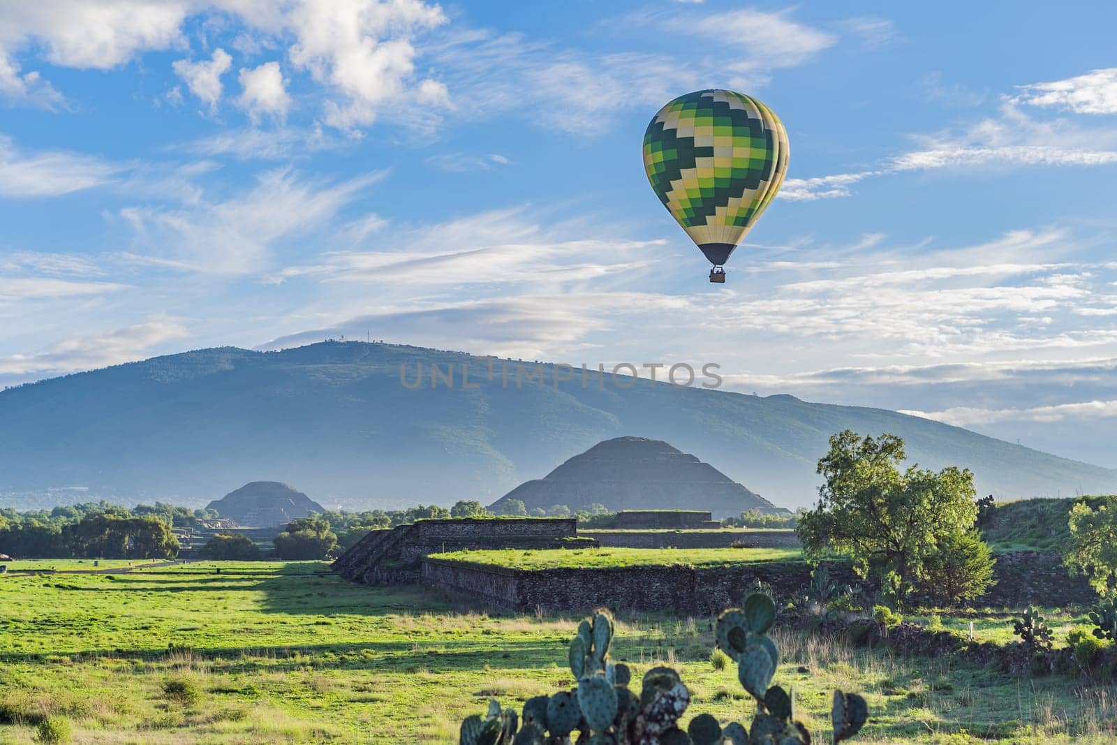 An aerial view of hot air balloons above the Teotihuacan pyramid. Adventure travel, cultural heritage, and aerial exploration concept.