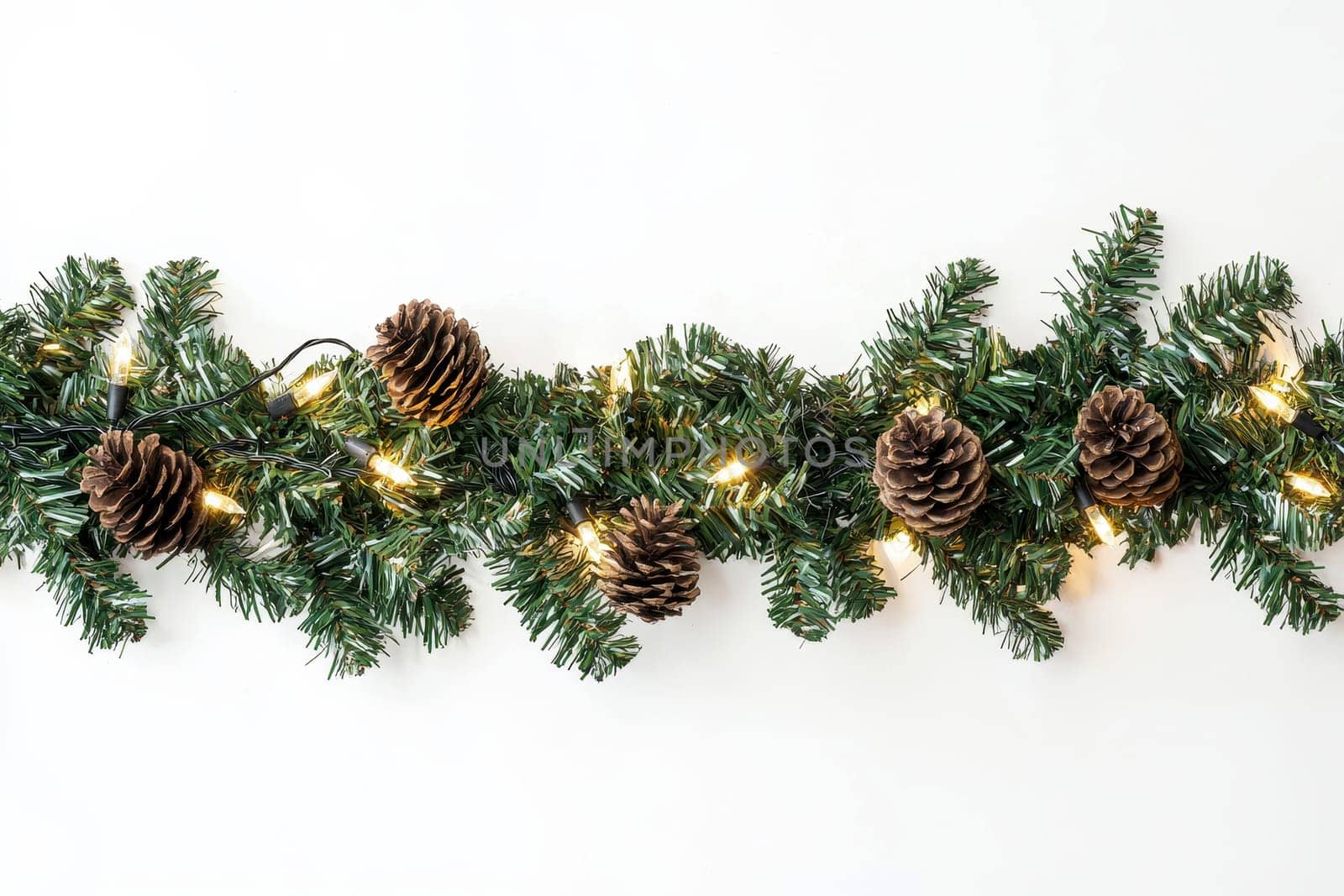 green garland with lights and pine cones on isolated white background..
