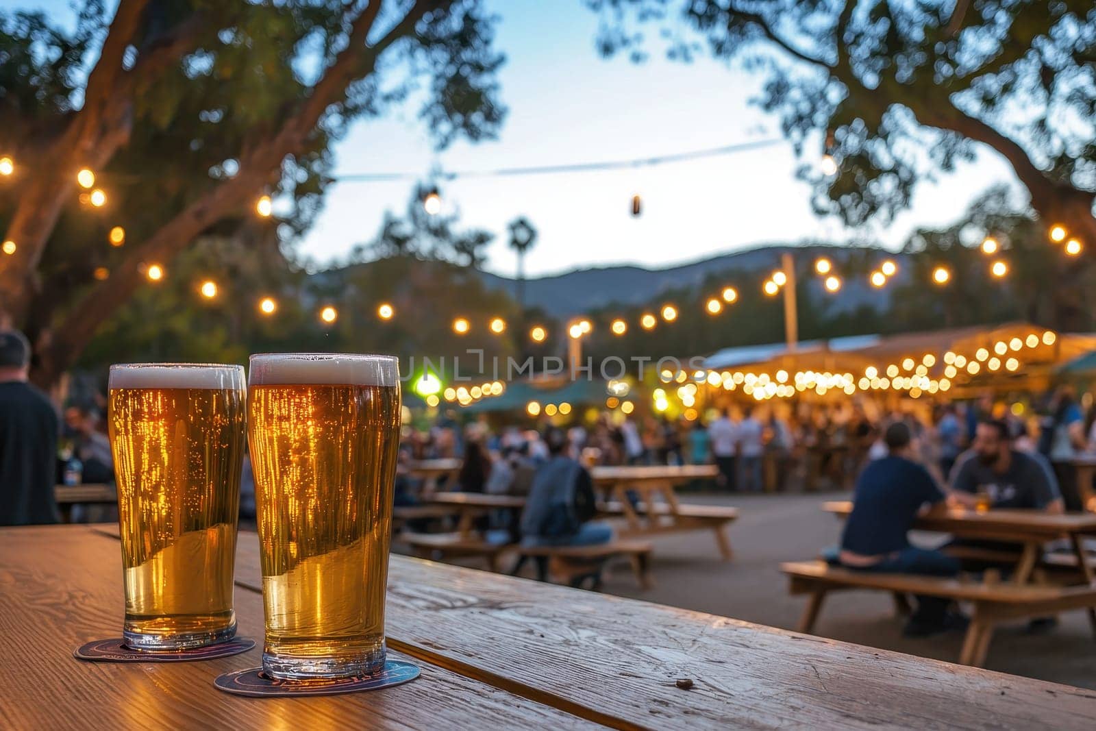Enjoy a vibrant night at a festival beer garden, featuring illuminated outdoor seating and people enjoying drinks and laughter under twinkling lights.