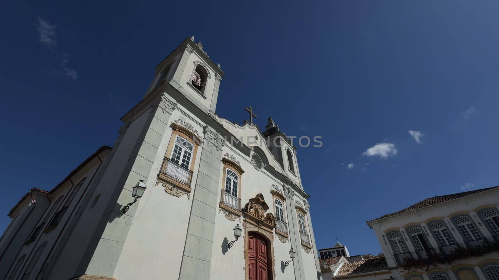 A video showcases a colonial church in Brazil where a tour guide explains the building's history and architecture to a visiting group.
