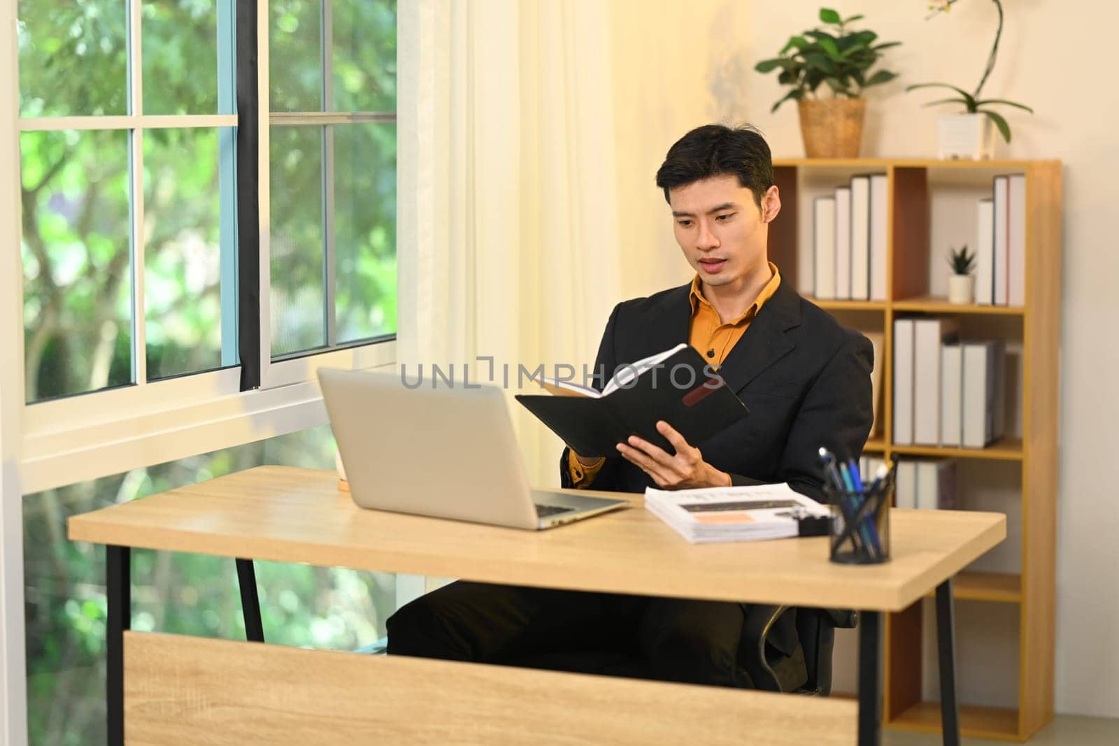 Professional businessman concentrating on work in a modern office.