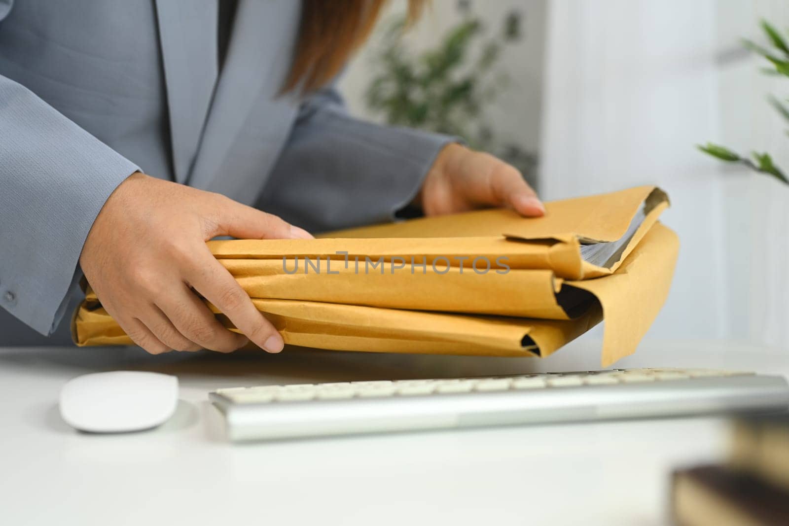 Cropped shot office worker managing document folders in office.