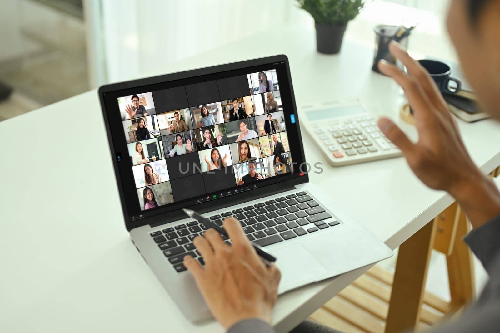 Businessman participating in online team meeting via video chat.
