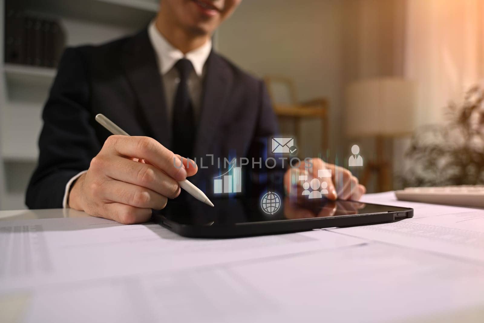 Businessman using digital tablet analyzing market trends with technology in modern business.