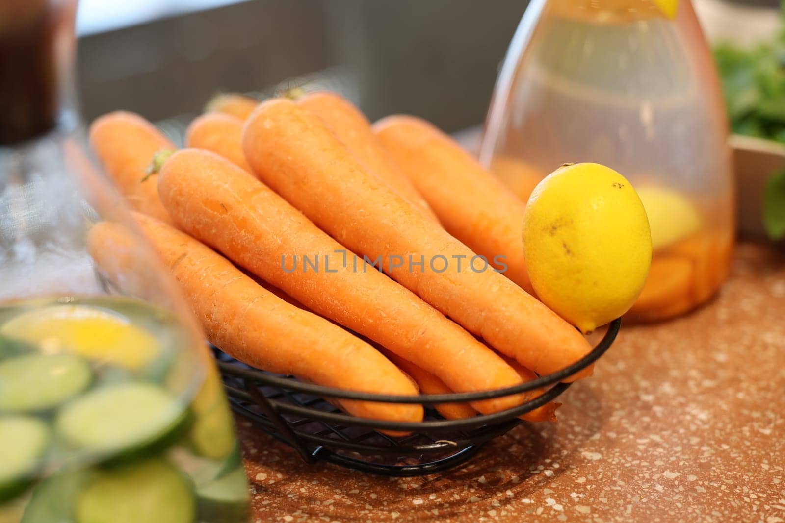 A beautifully vibrant arrangement of fresh, crunchy carrots and a zesty lemon, ideal for healthy cooking and meals