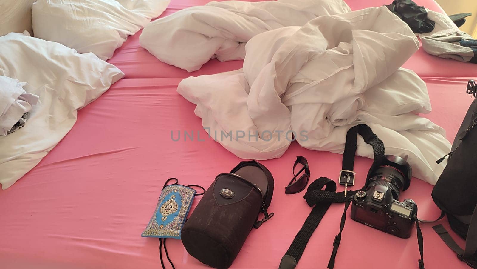 October 22 2024 Hradec Kralove, Czech Republic Europe, Kralov region, Kralovehradecky kraj, Canon 6D camera lies on the bed in white pink bed. High quality photo
