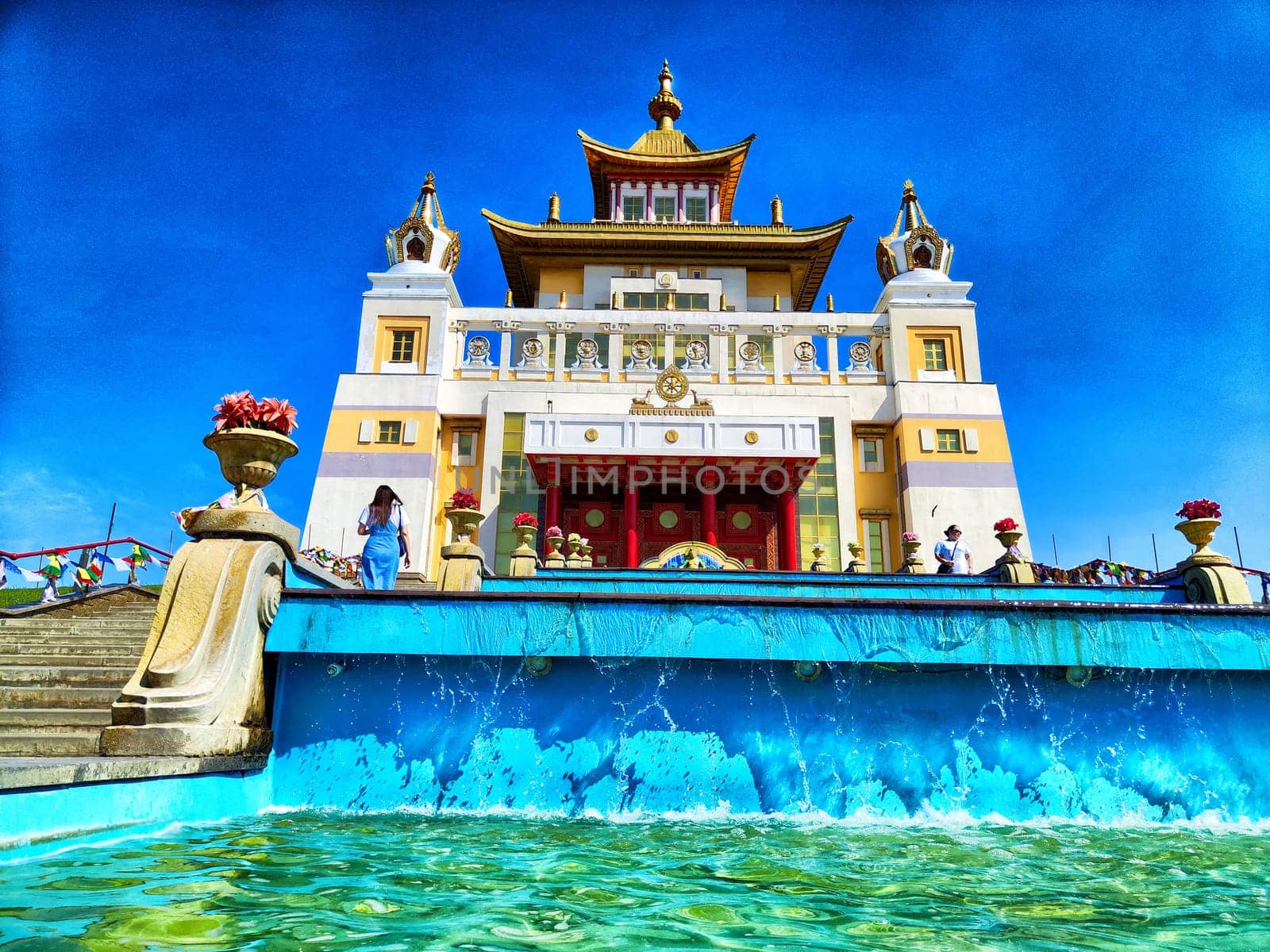 The Buddhist Golden Temple in Elista, Russia. The temple is adorned with intricate architecture and details, and the sky is blue and cloudless