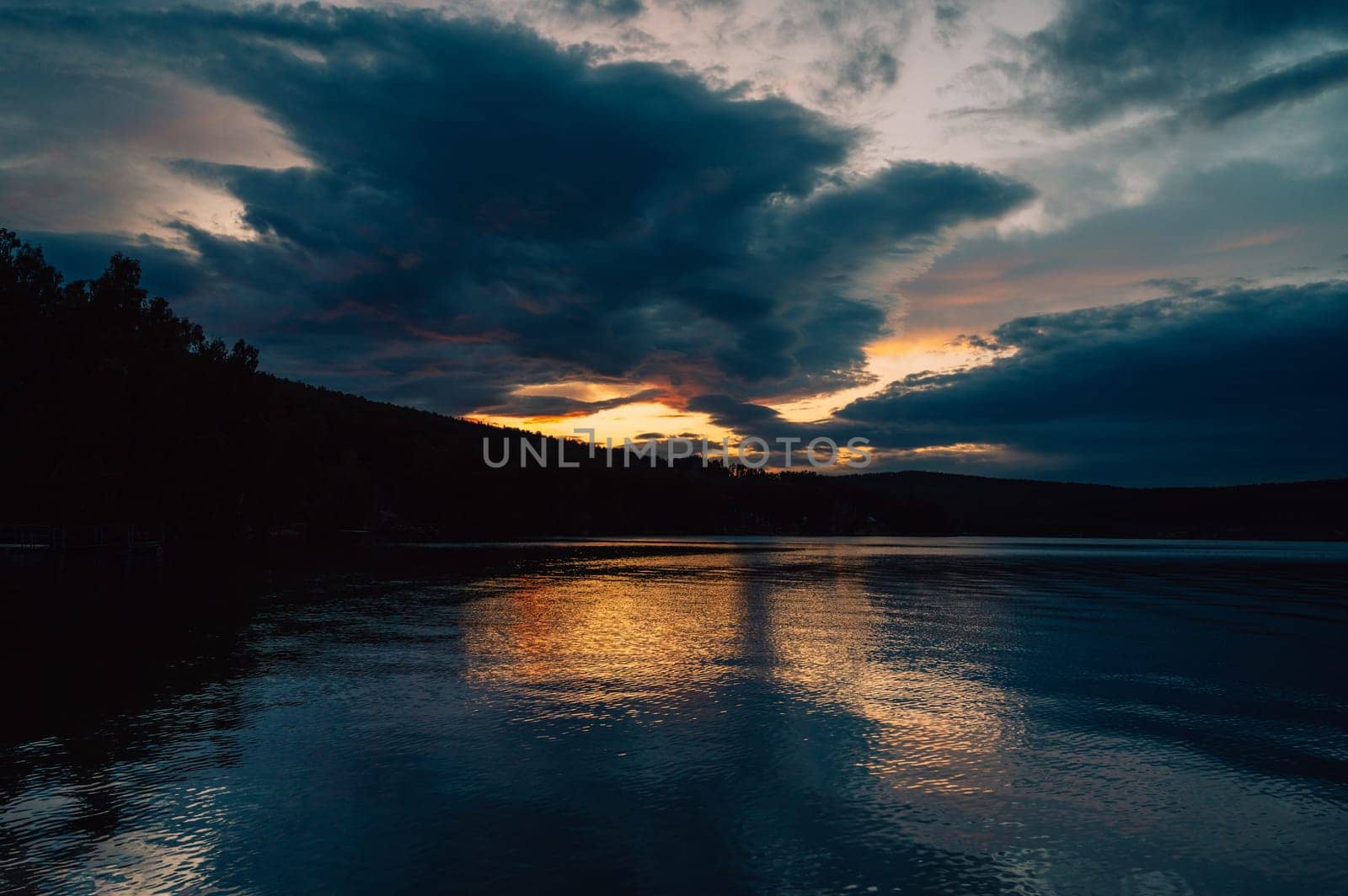 A calm and silent evening at beauty sunset at the summer lake